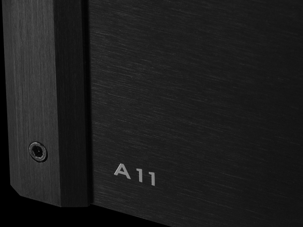 Closeup photo of the A11 logo on the front of a black amplifier chassis