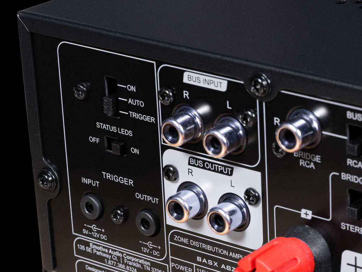 Close-up of an audio equipment panel with various connectors and labels on a black background.