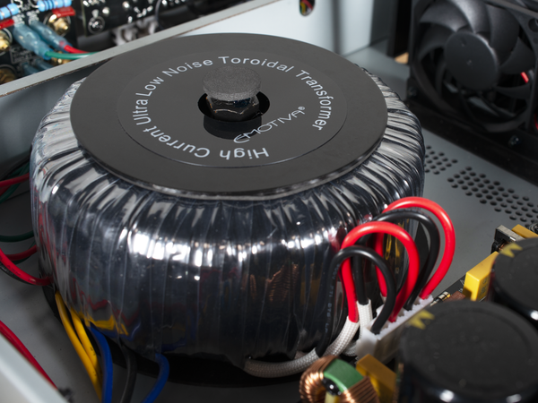 Toroidal transformer with visible branding on a technical background