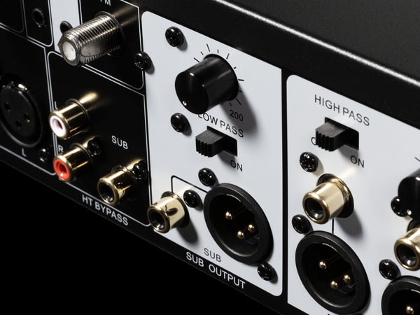 Close-up of audio equipment panel with various connectors and switches.