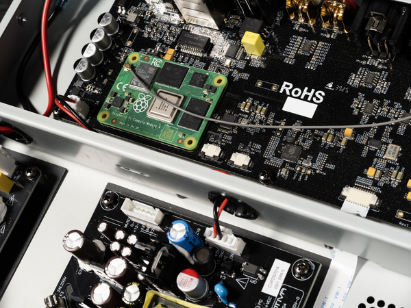 Close-up of electronic circuit boards with visible 'RoHS' marking on a white background