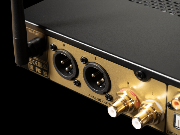 Close-up of audio equipment with analog output connectors on a black background