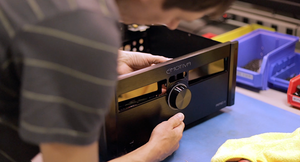 Person working on a Emotiva Electronics device in a workshop setting