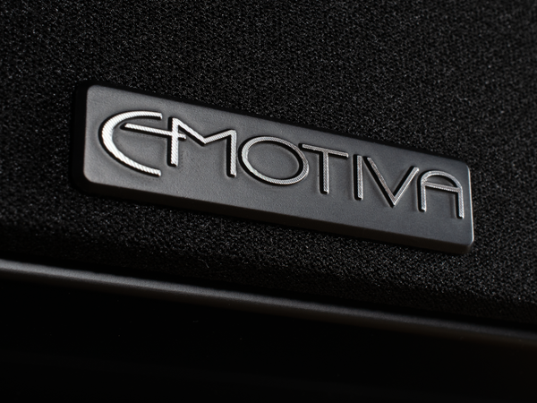 Metal badge on bottom of Airmotiv X loudspeakers featuring the Emotiva logo
