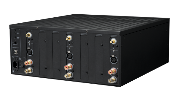 Black modular power amplifier rear view showing multiple terminal connectors and ports on a white background.